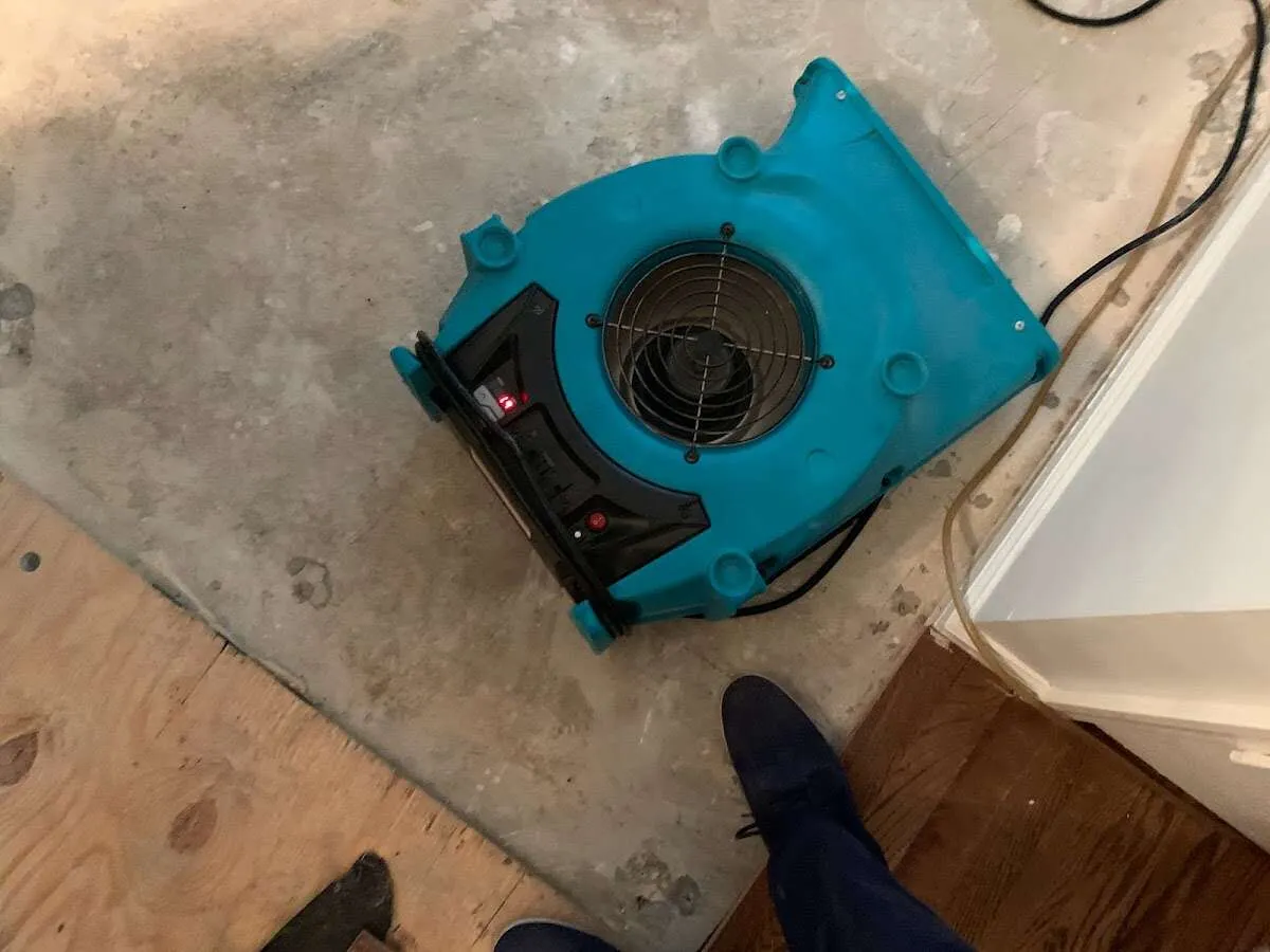 Air mover drying subfloor during Commercial Water Damage Restoration in Spanish Fort